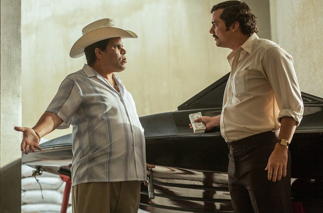 LUIS GUZMAN (L) and WAGNER MOURA (R) stars in NARCOS. NARCOS S01E02 "The Sword of Simon Bolivar"