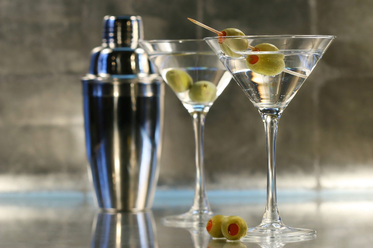 Martinis with olives and shaker on bar